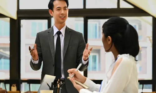 confident-businessman-explaining-project-details-2024-12-01-11-36-25-utc